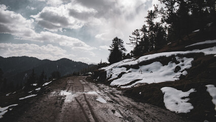Dirt road in snowy mountains