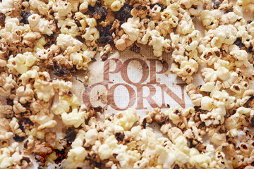 Burnt popcorn from a home microwave. Burn corn kernels on the kitchen table