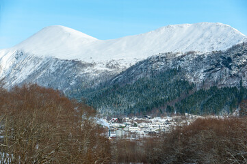 Fototapeta na wymiar snowy mountains above small town