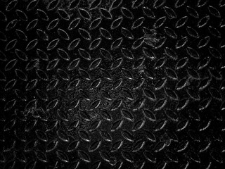 Blank space on black metallic checker plate anti-slip texture background. Abstract black metal sheet, close-up texture, black and white style.