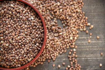 Peeled groats of buckwheat  on the background wood