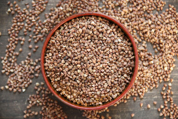Peeled groats of buckwheat  on the background wood