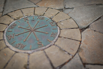 Fototapeta na wymiar Compass on ground in the park