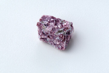 Mineral stone lepidolite. Macro shooting of natural gemstone. The raw mineral, white backround