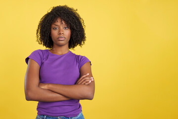 Angry woman with afro hair standing with arms crossed