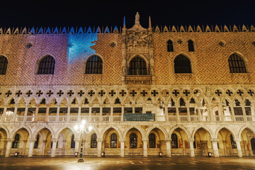 Fototapeta premium Venice Italy night view of illuminated Palazzo Ducale landmark, 1340 Doges Palace built in Venetian Gothic style at St. Marks square.