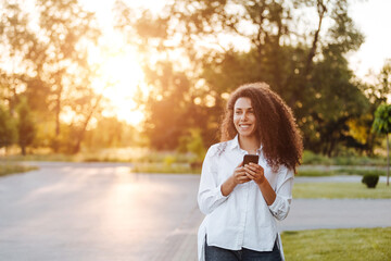 A young girl walks in the park.