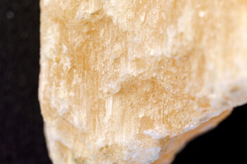 Red Gypsum stone mineral, black background, close-up, macro