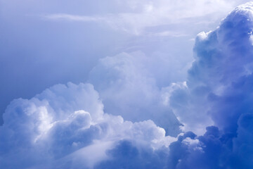 White cloud on blue sky. See through the plane window in sunny weather bird's eye view.