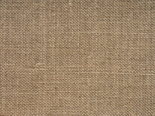 Natural light brown vintage linen canvas fabric texture. Stained, dirty, distressed material for making artwork, painting, designs decoration, background concepts, text, lettering, wall screen saver.