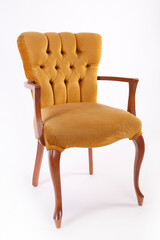 Yellow velvet vintage chair. Antique chair isolated on a white background.