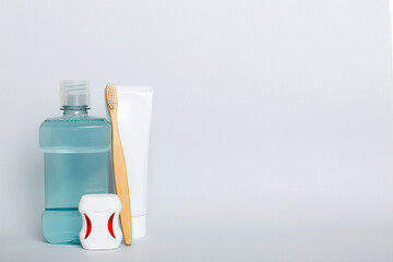 Mouthwash and other oral hygiene products on colored table top view with copy space. Flat lay. Dental hygiene. Oral care products and space for text on light background. concept