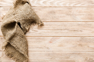 Old burlap fabric napkin, sackcloth on table background. top view with copy space