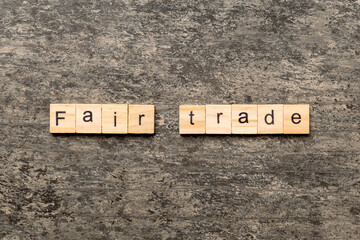 fair trade word written on wood block. fair trade text on cement table for your desing, concept