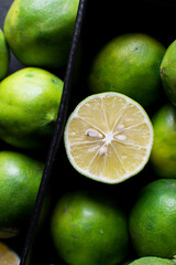 Top view of sliced green limes on a dark background, Flat lay of organic green limes