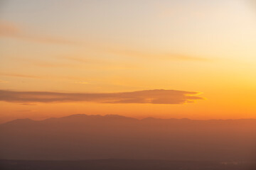 Bright sunset over the silhouette  mountains.