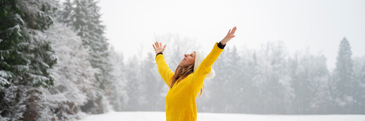 Young woman celebrating life standing in winter nature