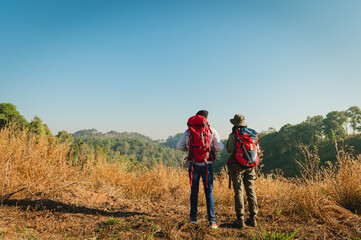 traveler couple with backpack standing looking view on mountain