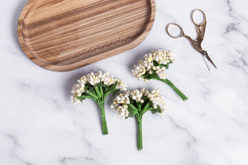 Decorative artificial flowers for creativity and scissors. Decorative bouquets. Top view