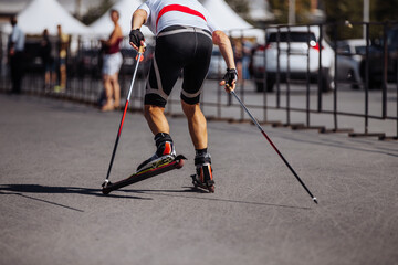 back man skier in roller skiing race