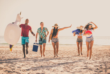 Happy multiethnic group of friends having summer vacation and having fun on the beach - Young...
