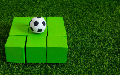 ball on green blocks , football and soccer sport betting concept