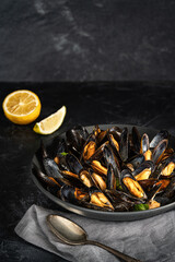 Mussels with lemon and herbs. Colorfully served table with seafood.