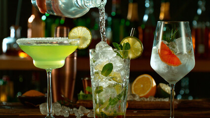Fresh various cocktails on the bar, dark toned background