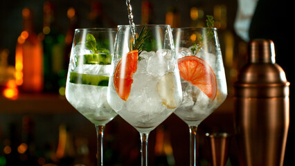 Fresh various cocktails on the bar, dark toned background