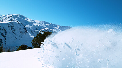Freeride skier riding in the scenic mountains with blue sky