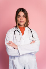 Doctor with stethoscope on pink background
