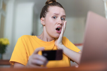 Internet fraud. Nervous sad upset unhappy confused young woman, stressed worried lady having...