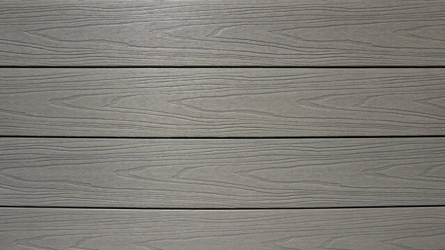 Fondo con textura de lamas marrones gris&aacute;ceas de madera pl&aacute;stica. Tarima de composite para exterior.