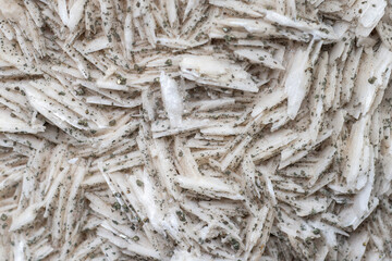 Small cube-shaped crystals of pyrite on milk-white barite. Natural minerals as background