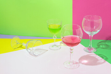 Cocktail glasses, bright fruity colors, creative aesthetic layout. Summer party idea. 
