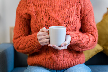 Cup of hot drink in armchair