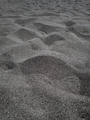 Fototapeta na wymiar black dry beach sand