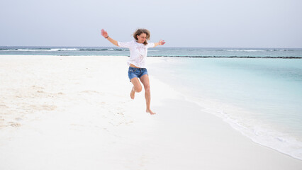 happy woman jumping on tropical beach