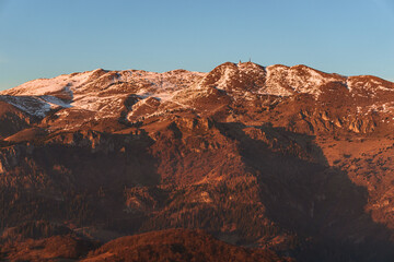The Lombard pre-Alps near Lake Iseo, seen at sunset from one of the most beautiful viewpoints in the Province of Brescia: Punta Almana, near the town of Sale Marasino, Italy - February 2023.
