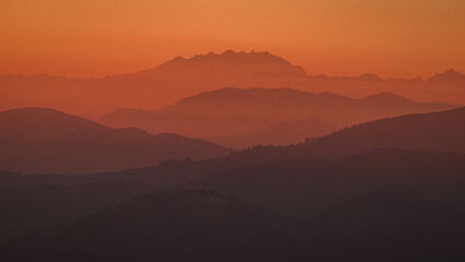 The Lombard pre-Alps near Lake Iseo, seen at sunset from one of the most beautiful viewpoints in the Province of Brescia: Punta Almana, near the town of Sale Marasino, Italy - February 2023.