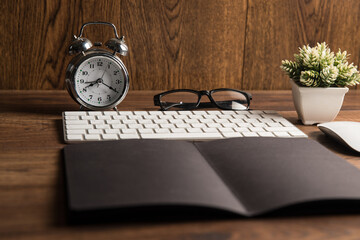 Keyboard, notepad, alarm clock and glasses