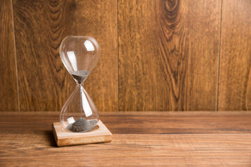 Glass hourglass on the table