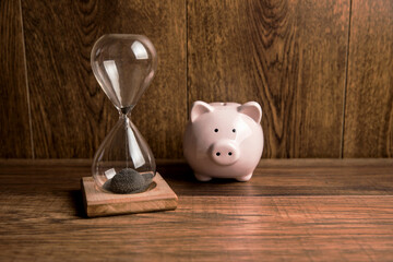 Glass hourglass and piggy bank