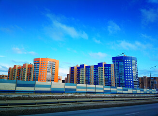 Blue and orange buildings on street highway backdrop