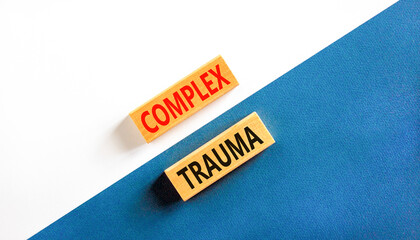 Complex trauma symbol. Concept words Complex trauma on wooden block. Beautiful white and blue table...