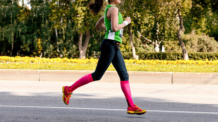young girl runner run marathon in city road