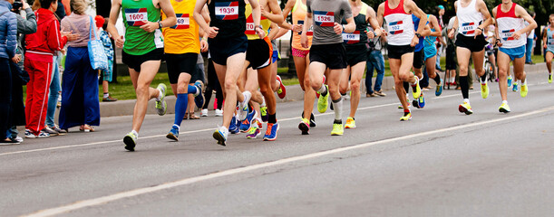 group runners athletes run marathon on city street