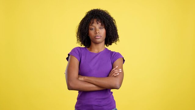 Angry woman with afro hair posing with arms crossed