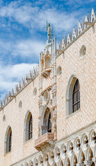 Magnificent main facade with luxurious balcony and statues with roof decorations of Doge Palace in...