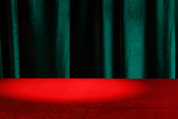 Modern background with empty red cloth table and green draped velvet curtains. Template for...